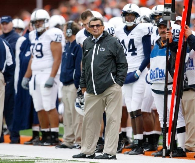 Penn State University head coach Joe Paterno looks toward the scoreboard during his team‘s game against the University of Illinois in their NCAA football game in Champaign, Illinois, U.S. October 3, 2009. REUTERS/Jeff Haynes/File Photo