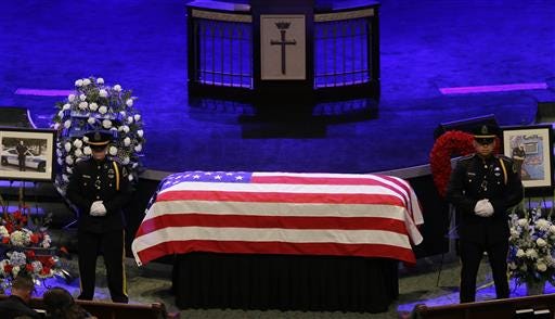 A honor guard stands watch over the casket of Dallas Police Sr. Cpl. Lorne Ahrens during his funeral service at Prestonwood Baptist Church in Plano, Texas, Wednesday, July 13, 2016. Ahrens and four other officers were slain by a sniper during a protest last week in downtown Dallas. (AP Photo/LM Otero)