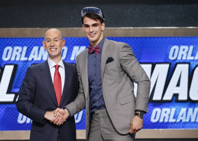 Dario Saric of Croatia (right) shakes hands with NBA commissioner Adam Silver after being taken with the No. 12 pick in the 2014 draft in Brooklyn.