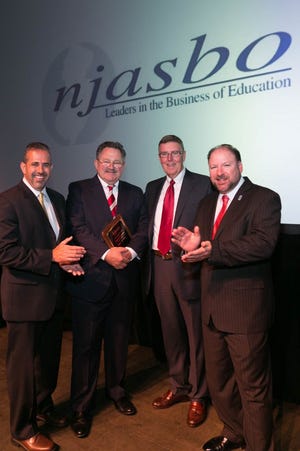 Lenape Regional High School District Business Administrator (BA)/Board Secretary James Hager, second from left, is applauded by his colleagues and officers with the New Jersey Association of School Business Officials (NJASBO) upon receiving the Distinguished Service Award. Pictured, from left, are 2015-16 immediate Past President Frank Ceurvels, Executive Director John F. Donahue, and President Louis Pepe. Hager was one of six NJASBO Distinguished Service Award winners.