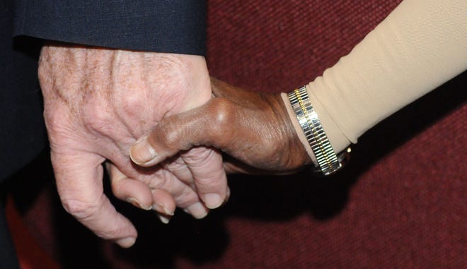 Rev. Bill Cook of St. Paul United Methodist Church in Willingboro and Evelyn Carson, of Willingboro, hold hands during a prayer vigil in response to the violence around the nation over the past week at the Parkway Baptist Church on Wednesday, July 13, 2016. The Willingboro Clergy Association hosted a peace prayer vigil for the community.