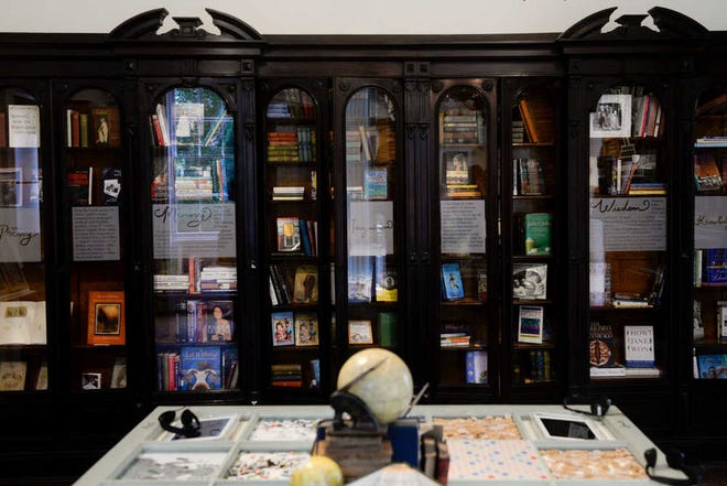 Ian Maule/ Savannah Morning News- A a bookcase and interactive table sit the new library at the Juliette Gordon Low Birthplace in Savannah on Wednesday, July 22, 2015. The bookcase is filled with books written by female authors and are allowed for check out by Girl Scout Troops. -Savannah Morning News