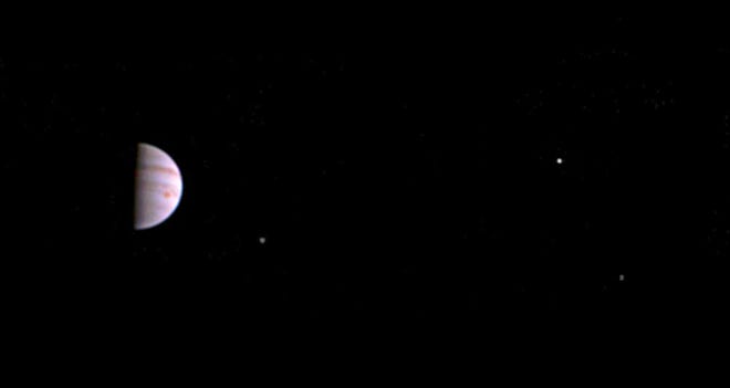 This July 10 image released by NASA was taken by the Juno spacecraft five days after it arrived at Jupiter. The image shows Jupiter's Great Red Spot and three of its four largest moons.