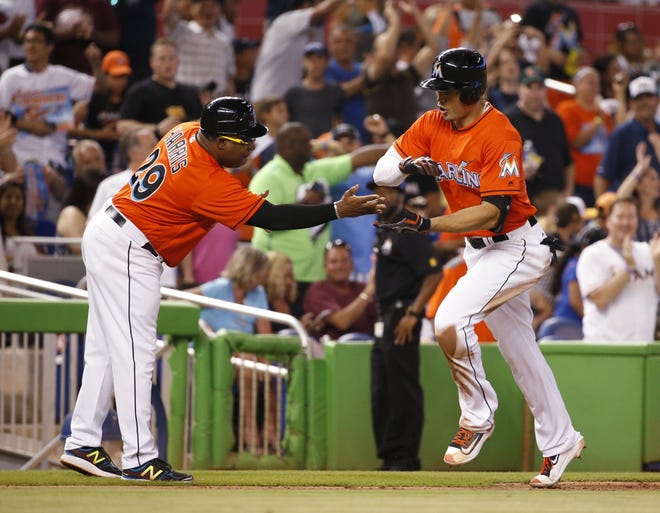 Miami's Giancarlo Stanton, right, is a major part of the Marlins' return to contention in 2016. ASSOCIATED PRESS
