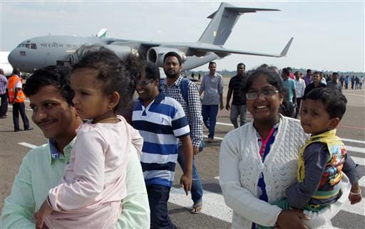 Indian nationals arrive from South Sudan's capital Juba at Entebbe International Airport, about 42 kilometers east of capital Kampala, Uganda, Thursday, July 14, 2016. The United States, India and other countries continue to evacuate their citizens from South Sudan, where a fragile cease-fire appears to hold amid fears of a return to civil war. (AP Photo/Stephen Wandera)