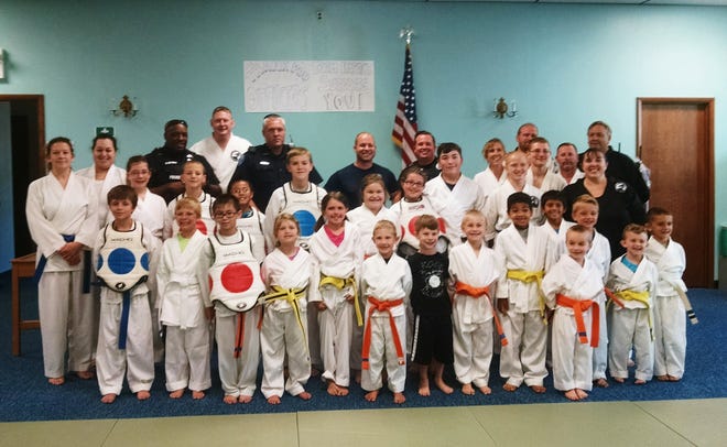 Students at Impact Martial Arts in Canal Fulton recently thanked area police for their service with a show of support.

(Submitted photo)