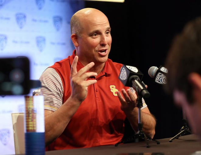 USC head coach Clay Helton talks about 'juggling' several roles during his time at USC as he speaks to reporters at the Pac-12 NCAA college football media day in Los Angeles Thursday, July 14, 2016.