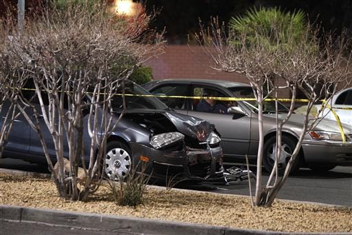In this 2014 file photo, a damaged car is seen at the scene of a fatal road rage incident in Las Vegas. Authorities say a man shot a motorist to death in a vehicle with two children in the backseat in an apparent road-rage confrontation during rush-hour several miles west of the Las Vegas Strip. Nearly eight of every 10 U.S. drivers admit expressing anger, aggression or road rage at least once in the previous year, according to a new survey released Thursday.