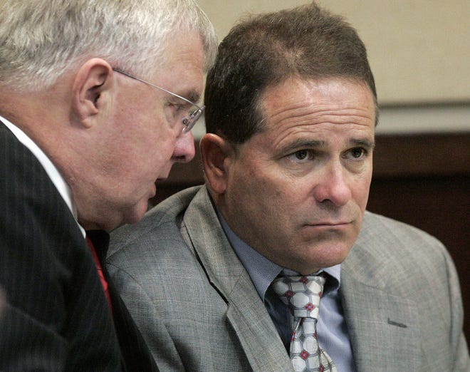 Jay Odom, right, listens to his attonrey in this Monday, March 21, 2011 file photo. Odom is backing an Alachua medical marijuana operation. (AP file photo)