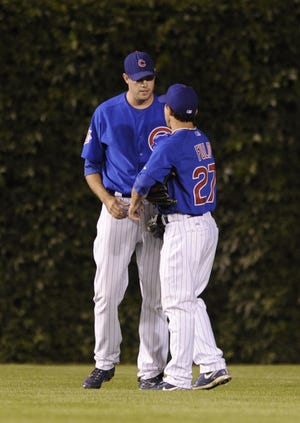 Chicago Cubs pitcher Sean Marshall left, talks with center fielder Sam Fuld after manager Lou Piniella put Marshall in left field in the ninth inning of a game in 2009. More pitchers have been playing in the outfield, either as part of a matchup strategy, or in case the team runs out of position players. Associated Press