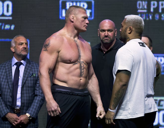 Brock Lesnar, left, looks at Mark Hunt during the UFC 200 weigh-ins in Las Vegas, Friday, July 8, 2016. (L.E. Baskow/Las Vegas Review-Journal via AP)