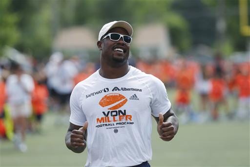 FILE - In this June 22, 2016, file photo, Denver Broncos linebacker Von Miller runs with participants, as the Super Bowl 50 MVP hosts a football camp for kids on a high school field, in Englewood, Colo. Miller has agreed to a blockbuster $114.5 million contract with the Denver Broncos that includes $70 million in guarantees and makes him the highest-paid nonquarterback in NFL history.Â The Super Bowl MVP accepted the six-year offer two hours before Friday's, July 15, 2016 deadline, tweeting a photo of himself with the caption "For Life." (AP Photo/David Zalubowski, File)