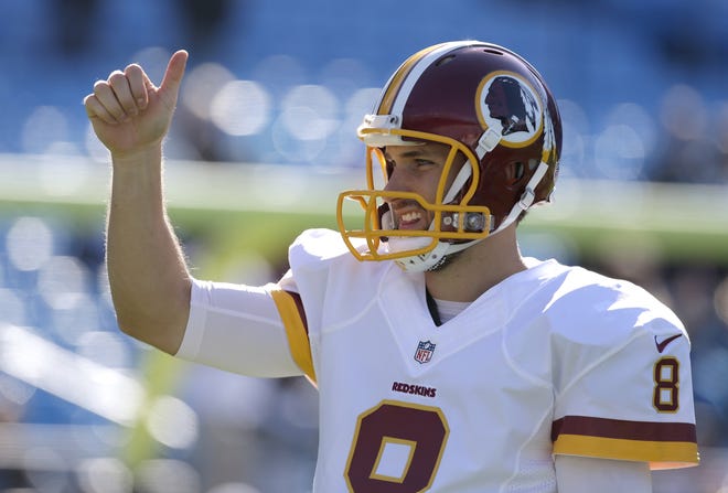 Washington Redskins' Kirk Cousins (8) warms up before an NFL football game against the Carolina Panthers in Charlotte, N.C., Sunday, Nov. 22, 2015. (AP Photo/Bob Leverone)