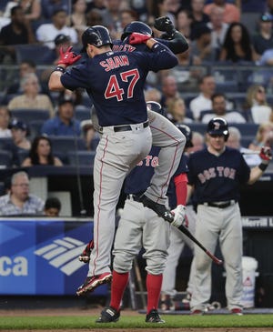 Travis Shaw (47) and Jackie Bradley Jr. celebrate at home plate after Shaw hit a two-run home run against the Yankees in the fifth inning Friday night.