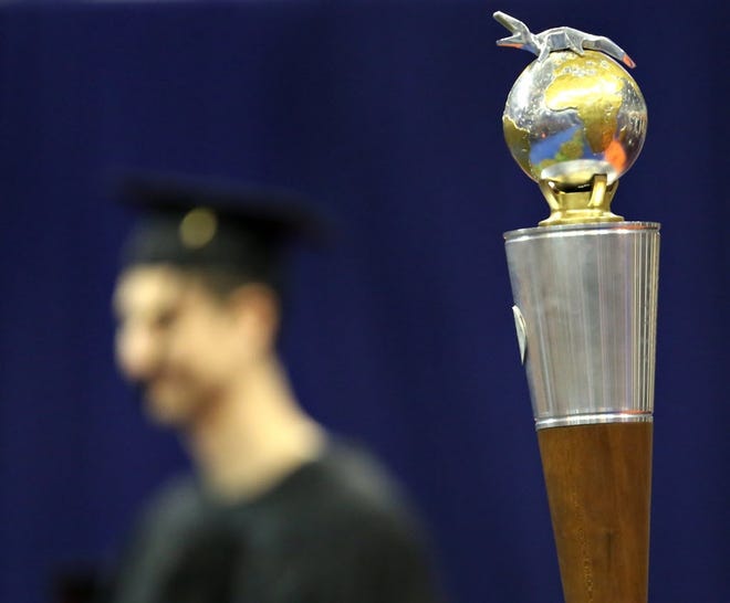 Doctoral graduates cross the stage during a commencement ceremony at the University of Florida. (File)