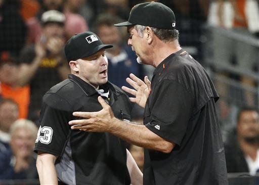 San Francisco Giants manager Bruce Bochy argues with umpire Mike Estabrook during the ninth inning of a baseball game against the San Diego Padres on Friday, July 15, 2016, in San Diego. Bochy was ejected. The Padres won 4-1. (AP Photo/Lenny Ignelzi)