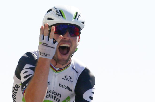 Mark Cavendish celebrates as he crosses the finish line of the 14th stage of the Tour de France on Saturday in Villars-les-Dombes, France. ASSOCIATED PRESS/PETER DEJONG