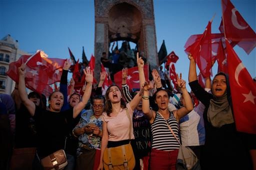 People chant slogans as they gather at a pro-government rally in central Istanbul's Taksim square, Saturday, July 16, 2016. Forces loyal to Turkish President Recep Tayyip Erdogan quashed a coup attempt in a night of explosions, air battles and gunfire that left some hundreds of people dead and scores of others wounded Saturday. (AP Photo/Emrah Gurel)