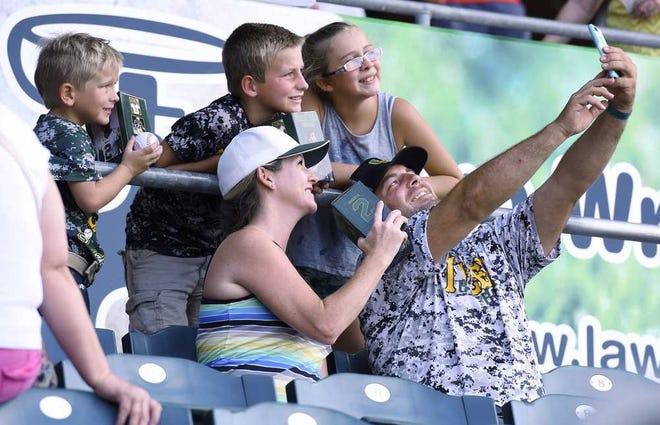 Bob.Self@jacksonville.com The Westfall family (from left) of Kyle Jr., 6, Karson, 9, Kelsey, 13, and their parents Tara and Kyle, from Yulee, take a group selfie with their Derrick Henry bobbleheads before the start of Saturday's Jacksonville Suns game.
