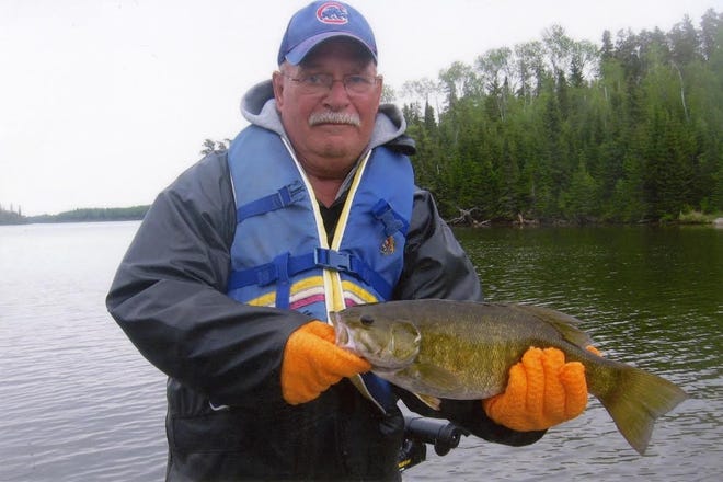 Dick Ronna of Pekin poses with a 4-pound smallmouth bass in May at Vermilion Bay, Ontario, Canada.