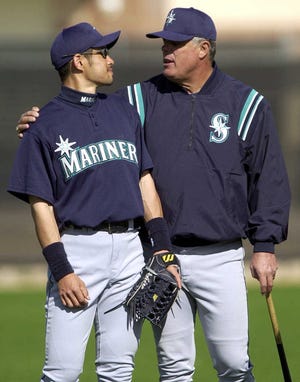 In this Feb. 21, 2001, file photo, the Seattle Mariners' manager Lou Piniella puts his arm around Ichiro Suzuki as workouts begin at their spring training camp in Peoria, Arizona.