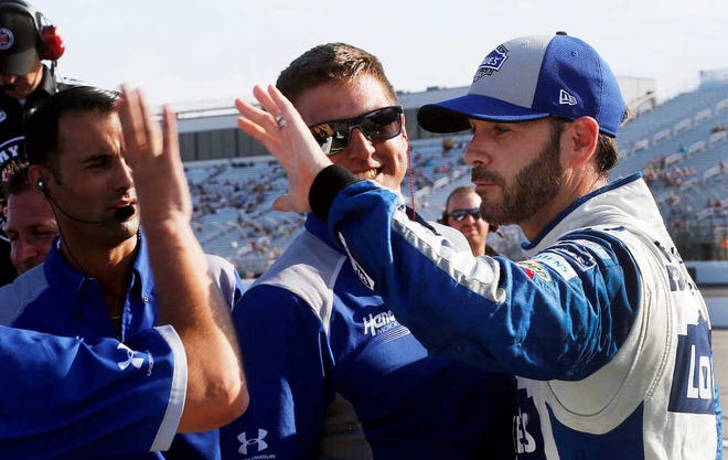 NASCAR driver Jimmie Johnson celebrates with his crew after winning the pole position at New Hampshire Motor Speedway on Friday for today's New Hampshire 301 in Loudon, N.H. (AP Photo/Jim Cole)