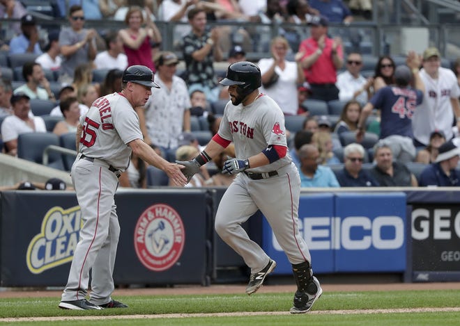 The Red Sox's Sandy Leon, right, is greeted by third base coach Brian Butterfield as he rounds the bases after hitting a three-run home run against the New York Yankees during the sixth inning Saturday in New York. Julie Jacobson/THE ASSOCIATED PRESS