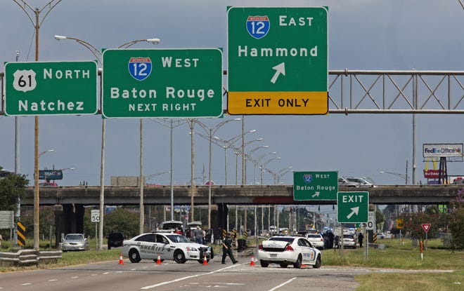 Baton Rouge police block Airline Highway after police were shot in Baton Rouge, La., Sunday, July 17, 2016. Authorities in Louisiana say several law enforcement officers are dead, and several injured in Baton Rouge after on-duty law enforcement officers were shot on Sunday morning. (AP Photo/Max Becherer)
