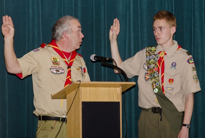 Boy Scout Troop 357 Eagle Coach Richard Ellison, left, has Zachary Shaw repeat the Eagle Scout Oath during an awrds ceremony Sunday at the Valley View Community School in Farmington. His Eagle Scout project was helping Families in Transition, which is an outreach program for families who are homeless. Photo by Daryl Carlson/Fosters.com