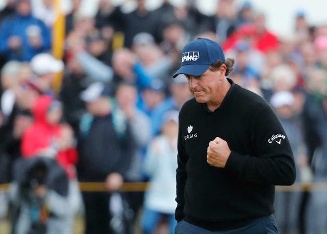 Phil Mickelson celebrates after making a birdie on the 13th green during the third round of the British Open in Troon, Scotland, on Saturday.