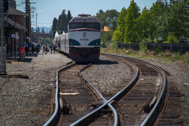 Passengers board an Amtrak Cascades train in downtown Eugene on Wednesday. (Brian Davies/The Register-Guard)