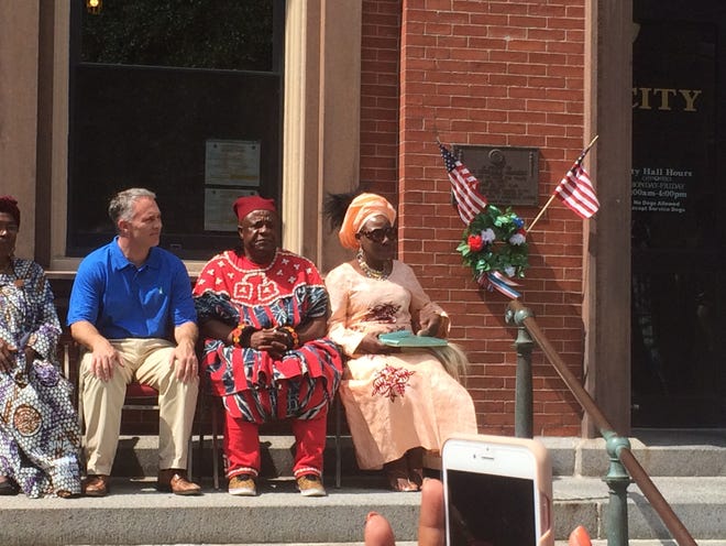 New Bedford Mayor Jon Mitchell sits alongside King Vincent Tchoua Kemajou of the Cameroonian kingdom Bazou and his wife Friday during a flag raising ceremony at city hall. ERIC BOSCO/STANDARD-TIMES/SCMG