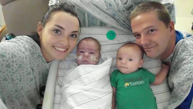 Cameron Smith and Taylor Buckley pose with their twin boys Brayden, right, and Chase. The couple said Chase, who is on oxygen and being monitored at Loma Linda University Medical Center, needs a heart transplant to survive. Photo courtesy of the Smith family