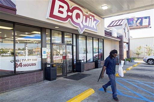 The B-Quick convenience store on Airline Highway where an encounter with a shooter left three law enforcement officers dead on Sunday is open for business in Baton Rouge, La., Monday, July 18, 2016. Several memorials are planned in Baton Rouge to honor the fallen law enforcement officers. (AP Photo/Max Becherer)