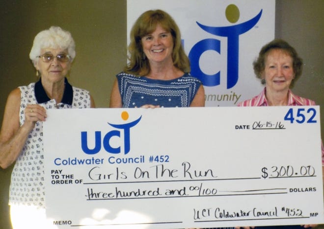 Cate Haberl, Girls on the Run Advisory Board President (center), accepts a donation from UCT council #452 represented by youth chair Qwen Kelly and UCT President Barb Fry. Girls on the Run had 160 participants this year and weekly to participate in the running sport and interact with other young ladies growing in maturity. A special event this year was the 10k run. About one-third of the girls receive a scholarship towards the $120 fee. Courtesy Photo