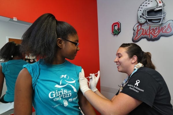 Kennedy Meadors, 12, gets a meningococcal vaccination from medical assistant Victoria Troyer at Pediatric and Adolescent Practitioners in Gahanna.