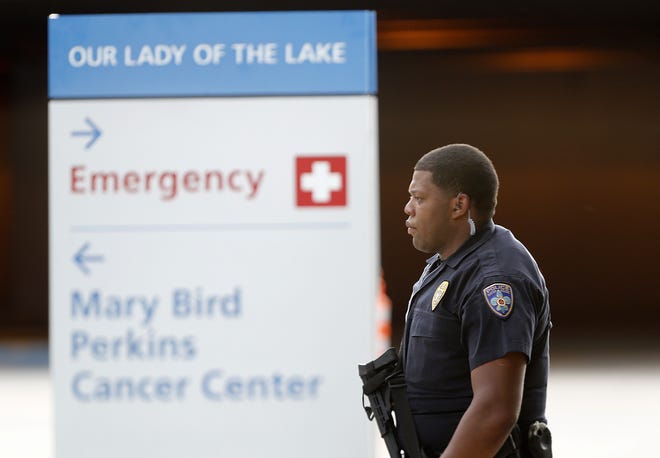 Police guard the emergency room entrance of Our Lady Of The Lake Medical Center, where wounded officers were brought, in Baton Rouge, La., Sunday, July 17, 2016. Multiple law enforcement officers were killed and wounded Sunday morning in a shooting near a gas station in Baton Rouge. (AP Photo/Gerald Herbert)