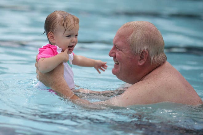 Tim Dolozal swims with his grand daughter, Madison Dolezal, 1, at Bishop Park pool Tuesday, July 19, 2016. (Photo/ John Roark, Athens Banner-Herald)