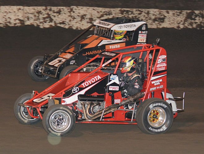 Zach Daum runs below Tanner Thorson during the feature of the midgets, who made a return to Fairbury American Legion Speedway Saturday.