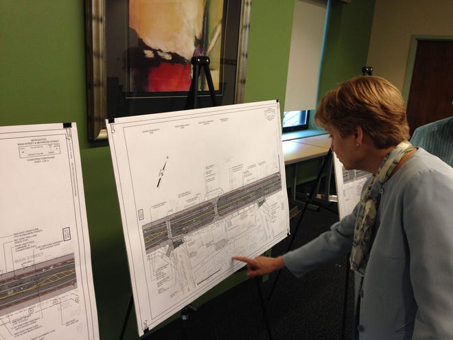 A woman looks at a schematic during a public hearing Clark University on streetscape improvements proposed by the state Department of Transportationfor the area of Maywood and Main streets. T&G Staff/Steven H. Foskett Jr.