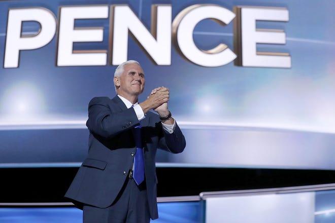 Vice presidential candidate Gov. Mike Pence, R-Ind., gestures as he arrives on stage to deliver his acceptance speech during the third-day session of the Republican National Convention in Cleveland on Wednesday.