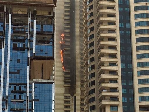 A fire rages at a skyscraper in the Dubai Marina section of Dubai, United Arab Emirates, Wednesday, July 20, 2016. It's the latest in a number of skyscraper fires across the United Arab Emirates in recent months. The most prominent was a New Year's inferno at a 63-story residence near the world's tallest tower. (AP Photo/Adam Schreck)