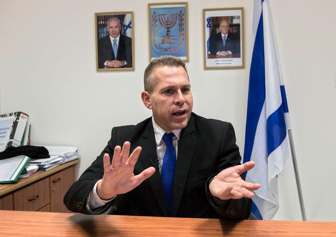 In this Thursday, July 14, 2016 photo, Israeli Public Security Minister Gilad Erdan speaks during an interview with The Associated Press in his office in Tel Aviv, Israel. Blaming incitement for the latest, 10-month spate of Palestinian attacks, Israel is taking its fight to a new level: A new law in the works, co-sponsored Erdan, aims to force Facebook and other social media platforms to take down content Israel deems as fueling violence. Some warn it goes too far, limiting free expression. (AP Photo/Tsafrir Abayov)