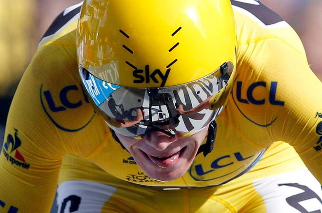 Britain's Chris Froome, wearing the overall leader's yellow jersey, crosses the finish line to win the eighteenth stage of the Tour de France on Thursday in Megeve, France.