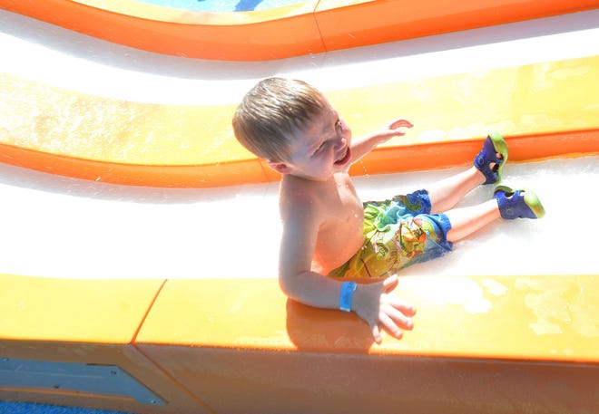 Gabriel Brown, 3, plays on the slide at the splash pad at Wooton Park in Tavares on Wednesday. (Amber Riccinto/ Daily Commercial)