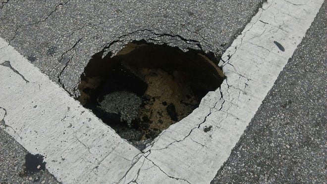 The right lane of Cypress Gardens Boulevard at Third Street Southeast is closed as Florida Department of Transportation crews repair what the FDOT is calling a sinkhole.