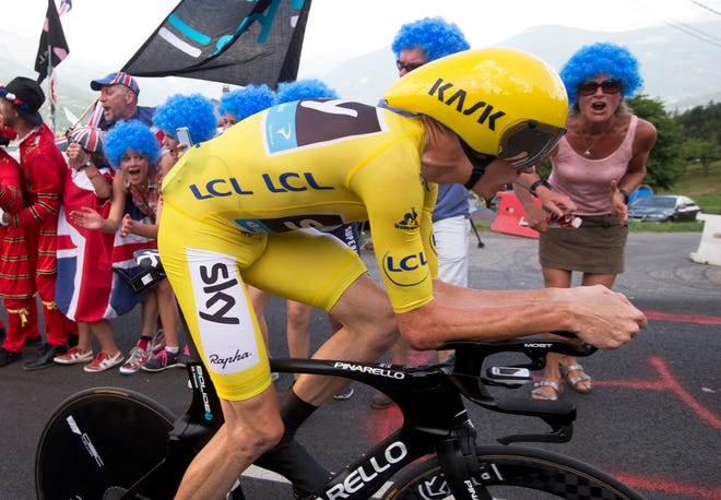 Supporters cheer Britain's Chris Froome, wearing the overall leader's yellow jersey as he rides during the eighteenth stage of the Tour de France cycling race, an individual time trial over 17 kilometers (10.6 miles) with start in Sallanches and finish in Megeve, France, Thursday, July 21, 2016.