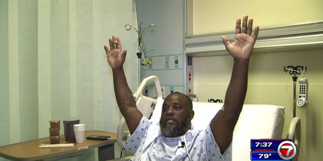 In this Wednesday, July 20, 2016, frame from video, Charles Kinsey explains in an interview from his hospital bed in Miami what happened when he was shot by police on Monday, July 18, 2016. Kinsey, a therapist who was trying to calm an autistic patient in the middle of the street, said he was shot even though he had his hands in the air and repeatedly told the police that no one was armed.