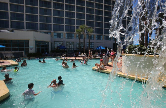 Guests along with non guests frolic in the Hilton Daytona Beach Oceanfront Resort pool on a recent Sunday. The area's largest hotel has opened 1 of its 2 pools to the public on Sundays as a way to draw more people to the Boardwalk area and the property's seven restaurants and lounges.

News-Journal/NIGEL COOK