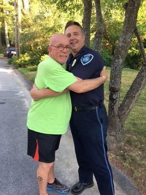 Ron Cole, a.k.a. Mr. Doin's, hugs North Hampton Police Chief Mike Maddox. Courtesy photo